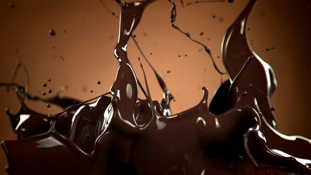 Super Slow Motion Shot of Splashing Melted Chocolate on Brown Gradient Background at 1000 fps.