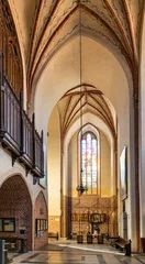 Poster Aisle of historic Holy Mary gothic Kosciol Mariacki church in old town quarter of Trzebiatow in Poland © Art Media Factory