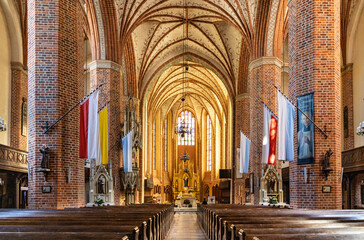 Main nave with altar and presbytery of historic Holy Mary gothic Kosciol Mariacki church in old town quarter of Trzebiatow in Poland