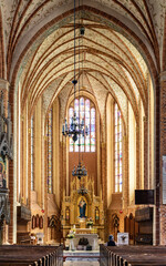 Main nave with altar and presbytery of historic Holy Mary gothic Kosciol Mariacki church in old...