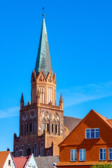 Fototapeta premium Historic Holy Mary gothic Kosciol Mariacki church in old town quarter of Trzebiatow in Poland