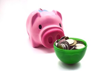 pink pig piggy bank with pile of coins in green cup on white background concept savings account savings bank finance business