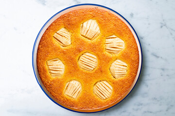 Sponge cake with apple pieces. Traditional French recipe.