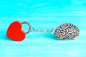 Red heart shaped padlock chained to a human brain
