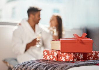 Christmas gift, present and happy couple celebrate the holiday at hotel with champagne. Love,...