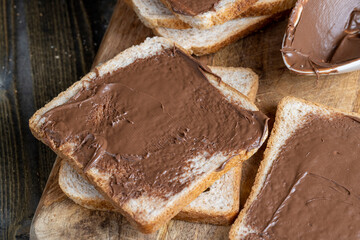 Chocolate butter spread on bread while cooking breakfast