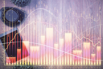 Multi exposure of financial chart hologram over desktop with phone. Top view. Mobile trade platform concept.