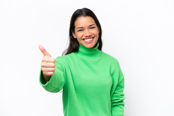 Young Colombian woman isolated on white background with thumbs up because something good has happened