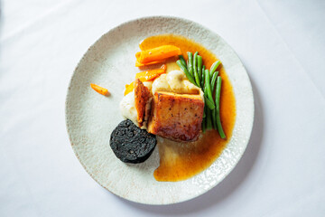 Slow roasted belly pork in a honey and soy glaze with black pudding, crackling and sage mash