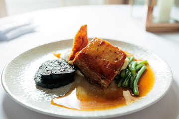 Slow roasted belly pork in a honey and soy glaze with black pudding, crackling and sage mash