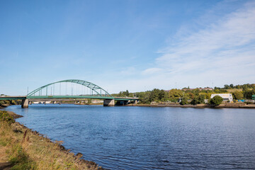 Blaydon England: 17th Sept 2022: View of Newcastle upon Tyne's Scotswood Bridge from the Tyne River in Blaydon. Sunny day with blue sky and light clouds
