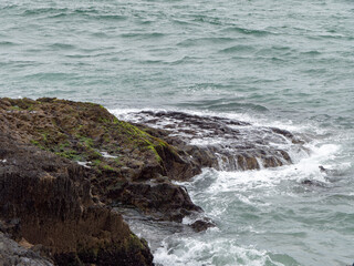 Fototapeta na wymiar Wild rocks and sea water, landscape, rock formation beside body of water. Ocean waves & Cliffs