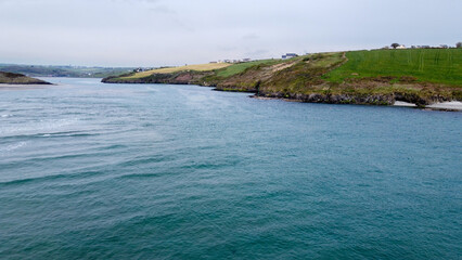 Beautiful turquoise sea water. Clonakilty Bay, the southern coast of Ireland. Seaside landscape on a cloudy day. Nature of Northern Europe.