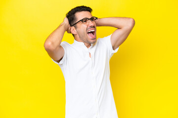 Fototapeta na wymiar Young handsome man over isolated yellow background stressed overwhelmed