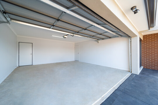 Empty double space garage with open gate.