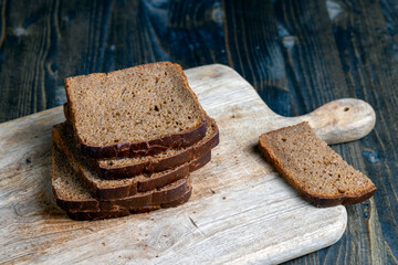 sliced rye bread on a wooden table, close up