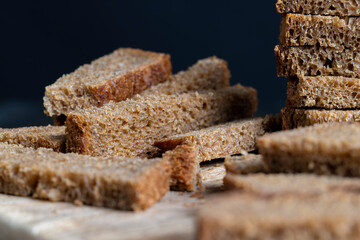 sliced rye bread on a wooden table, close up