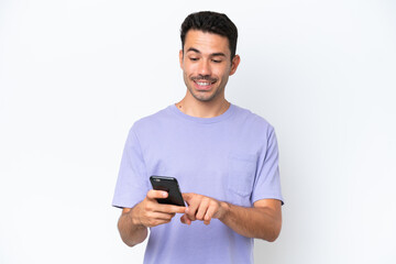 Young handsome man over isolated white background sending a message or email with the mobile