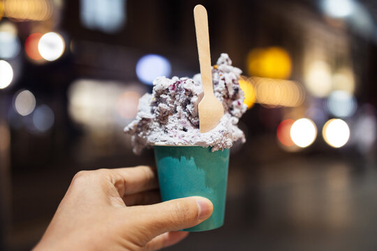 An image of ice cream at night city, concept of holiday, relaxing weekend, and having fun