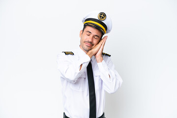 Airplane pilot over isolated white background making sleep gesture in dorable expression