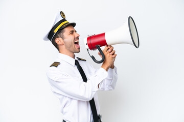 Airplane pilot over isolated white background shouting through a megaphone © luismolinero