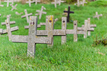 Tombstones in the old cemetery. Concrete tombstone crosses in the old cemetery.