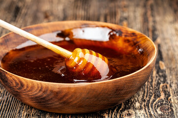 Sweet bee honey in a transparent glass jar