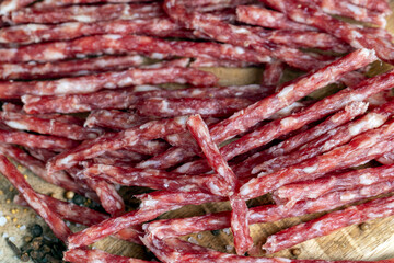 thin dried meat sausages with spices , close up