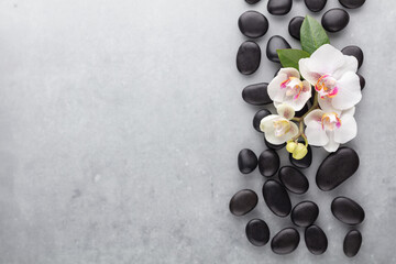 Obraz na płótnie Canvas Spa stone, orchid theme objects on grey background.