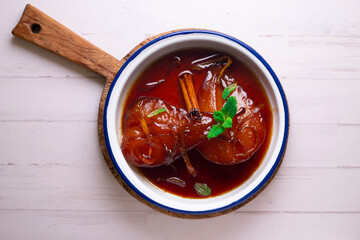 Pears cooked with red wine. Spanish traditional dessert recipe.