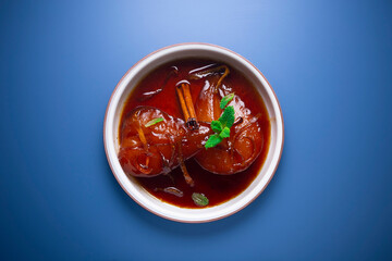 Pears cooked with red wine. Spanish traditional dessert recipe.