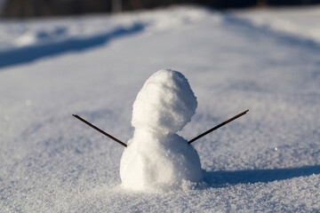 A little snowman in the snow in the winter season