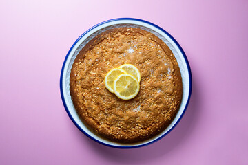 Lemon cake seen from above decorated with a few slices of fruit.
