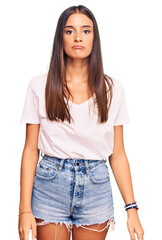 Obraz premium Young hispanic woman wearing casual white tshirt depressed and worry for distress, crying angry and afraid. sad expression.