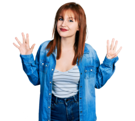 Redhead young woman wearing casual denim jacket showing and pointing up with fingers number nine while smiling confident and happy.