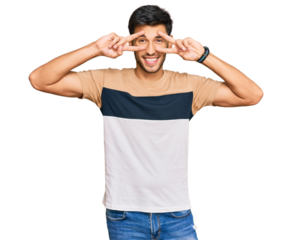 Young handsome man wearing casual clothes doing peace symbol with fingers over face, smiling cheerful showing victory