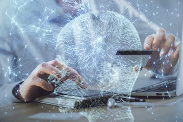 Double exposure of man hands typing on computer with credit card and brain theme drawing. E-commerce and AI concept.
