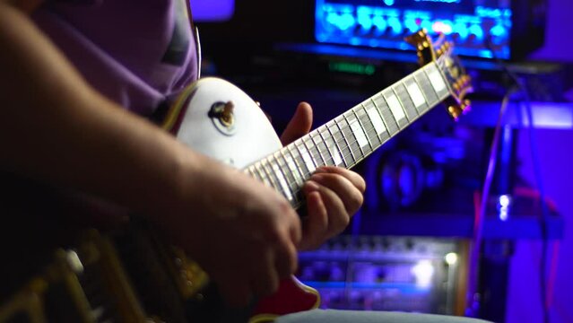lead guitarist playing electrical guitar at studio	
