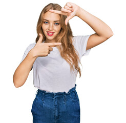 Young caucasian girl wearing casual white t shirt smiling making frame with hands and fingers with happy face. creativity and photography concept.