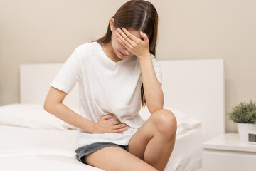 Flatulence ulcer, asian young woman, girl hands in belly, stomachache from food poisoning, abdominal pain and digestive problem, gastritis or diarrhoea. Abdomen inflammation, menstrual period people. - obrazy, fototapety, plakaty