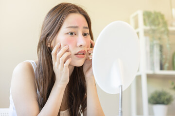Dermatology, puberty asian young woman, girl looking into mirror, allergy presenting an allergic...