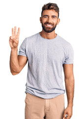 Young hispanic man wearing casual clothes showing and pointing up with fingers number three while smiling confident and happy.