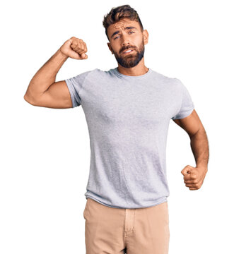 Young hispanic man wearing casual clothes stretching back, tired and relaxed, sleepy and yawning for early morning