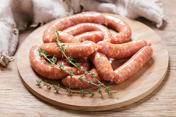 Fresh sausages on a chopping board