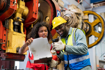 African workers working team service and discussing plan of maintenance machine in heavy industrial factory