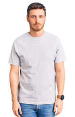 Obraz premium Handsome young man with bear wearing casual tshirt depressed and worry for distress, crying angry and afraid. sad expression.
