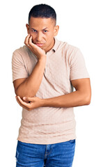 Young handsome latin man wearing casual clothes thinking looking tired and bored with depression problems with crossed arms.