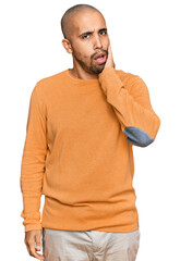 Hispanic adult man wearing casual winter sweater touching mouth with hand with painful expression because of toothache or dental illness on teeth. dentist