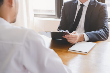 Asian young manager, employer man interview with person, have question about resume and listen to...