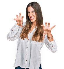 Young beautiful woman wearing casual clothes smiling funny doing claw gesture as cat, aggressive...